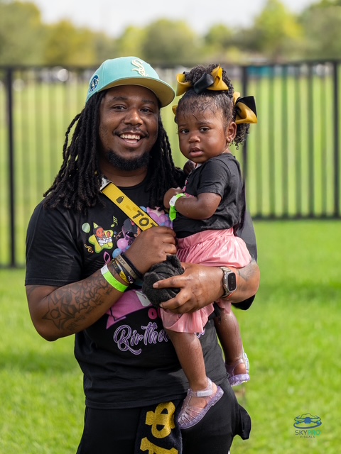 Father holding his daughter, smiling