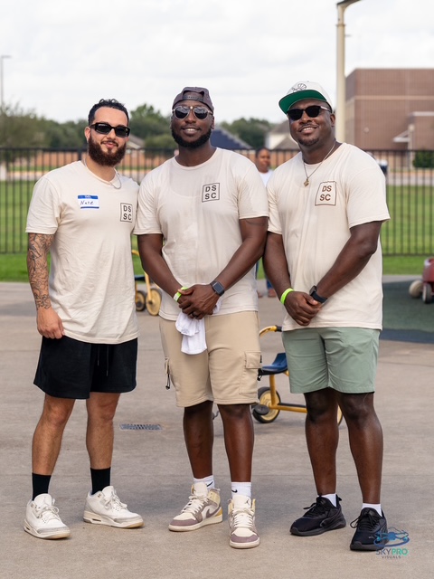 Three DSSC brothers standing together in matching tees