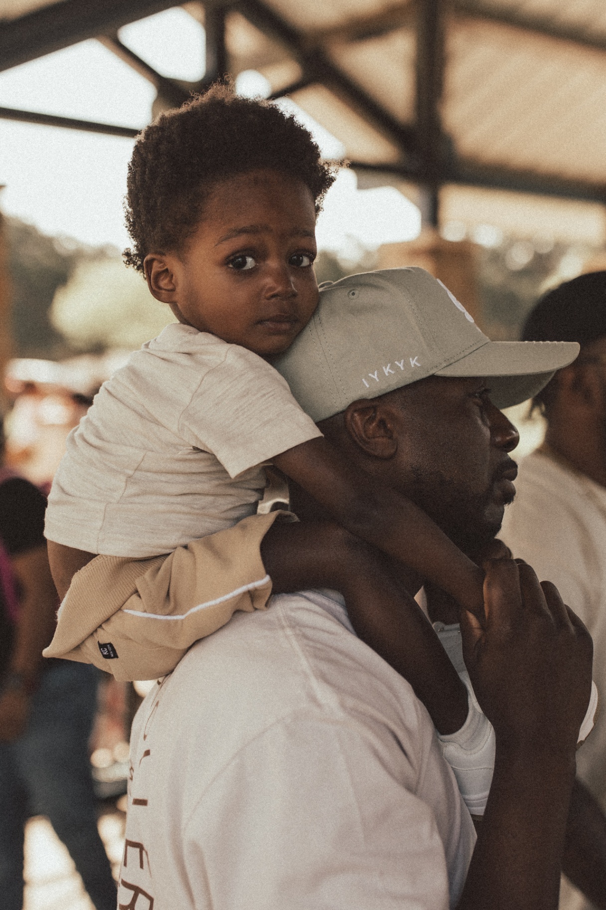A father carrying a child on his shoulder